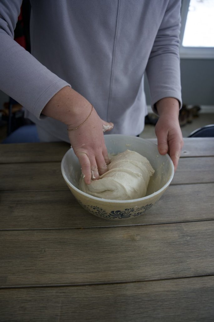 woman doing gentle fold in sourdough stretch and fold process
