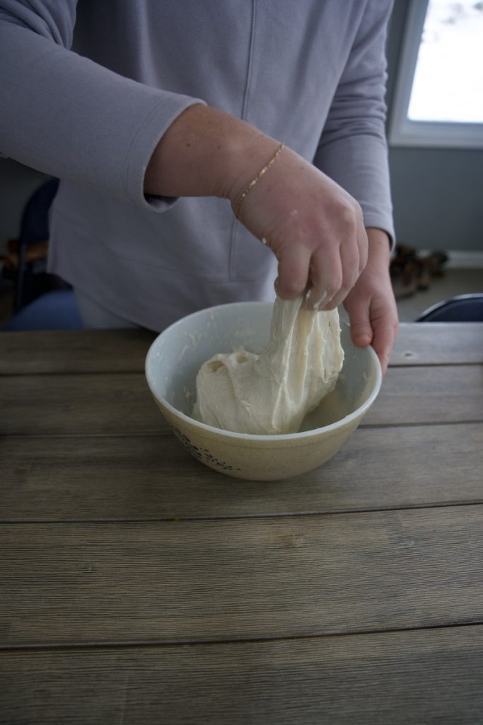 woman doing gentle stretch for sourdough stretch and fold process