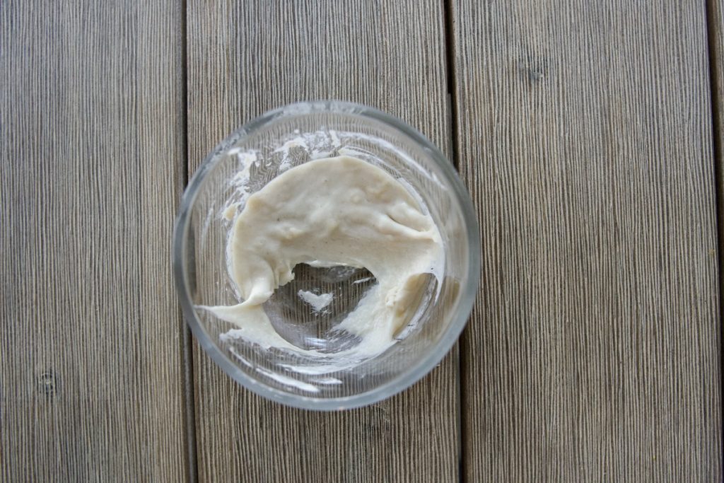 small glass bowl with 1/2 of flour and water mixture (discard) removed from mixture for simple sourdough starter recipe